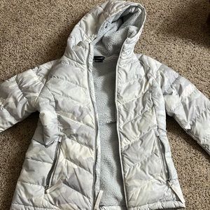 white and gray camo north face coat